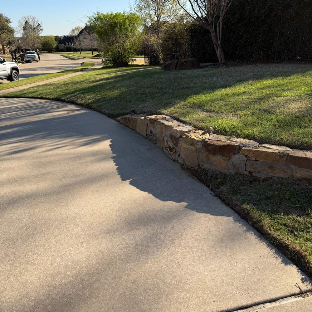 Clean concrete driveway and approach after pressure washing