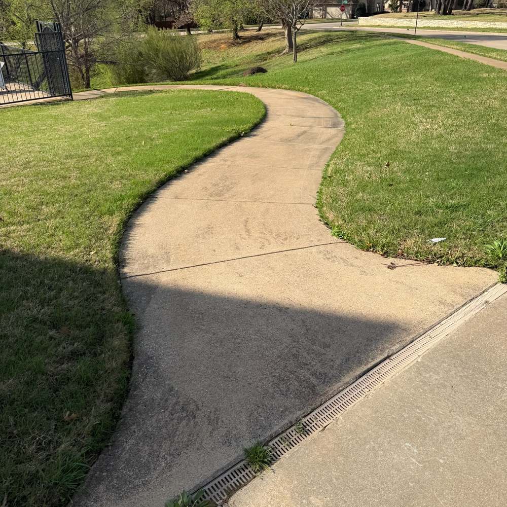 Curved sidewalk edged and pressure washed clean
