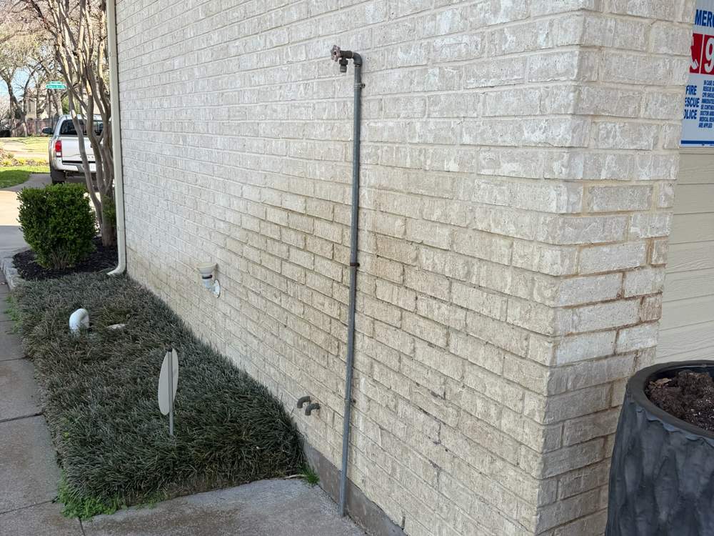Brick home exterior soft washed back to bright white